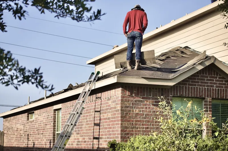 Professional roofer working on a residential roof in Mesa Verde
